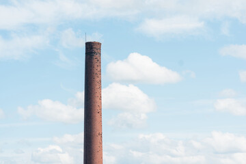 old brick factory chimney against the sky