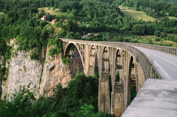Fototapeta premium Tara Bridge and Canyon, Tepca, Durmitor National Park, Montenegro - golden bridge over forest and rocks