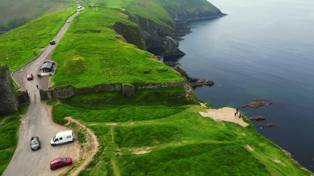A view of Ireland from the air and a UAV Drone looking at Old Head near Kinsale where there is a famous lighthouse and golf course with Ocean Cliffs