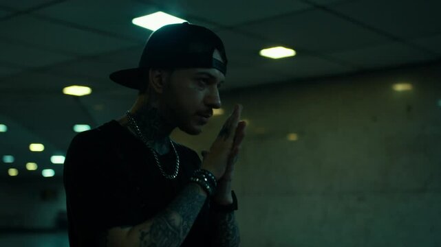 Guy walking at night, gangster fashion concept, underground tattoo guy.