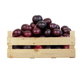 Cherry plums in wooden crate isolated on white background
