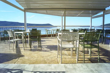 A cafe terrace with no customers. Holidays on the Mediterranean Sea outside the tourist season - photo from the promenade of Herceg Novi, Montenegro.