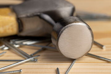 nails with small caps and an iron hammer on boards