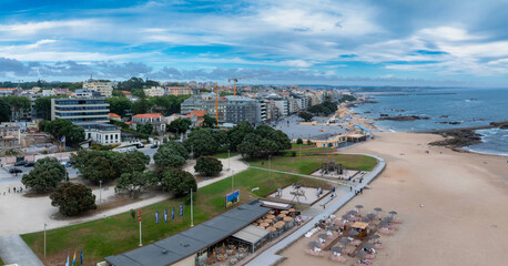Beautiful aerial view of the Anlantic ocean coastline near the city of Porto in Portugal. Sandy beach, by the ocean feshermen town.