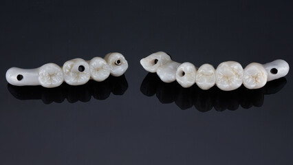 two dental bridge prostheses made of zircon for the chewing area on a black background