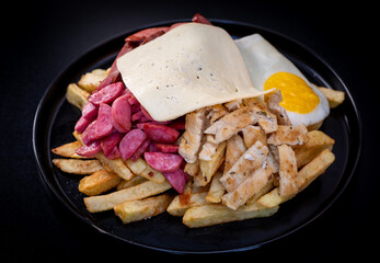 Peruvian culinary: Salchipapas, a fast food made with fried potatos, sausage, egg, bacon and many sauces like ketchup, mayonaise, mustard and hot pepper and chicken