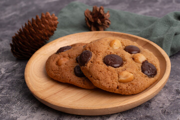 chocolate macadamia soft cookies on a table and plate