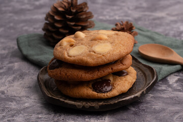 chocolate macadamia soft cookies on a table and plate