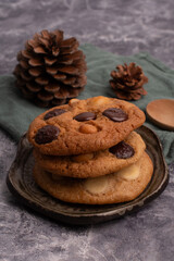 chocolate macadamia soft cookies on a table and plate
