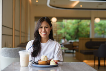 Young Thai Woman Enjoying Dessert at Coffee Shop