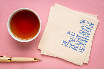 One small positive thought in the morning can change your whole day - inspirational handwriting on a napkin, positivity concept