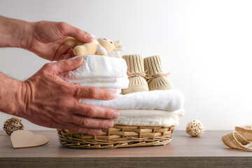Person leaving basket with clean cloths and baby changing diapers