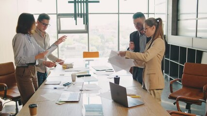 A productive collaborative team meeting is being held in a modern office. Businesspeople are engaged in brainstorming, discussions, and planning for future project developments