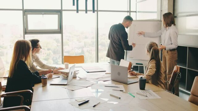 Successful business team meeting takes place in a modern office overlooking the city. Collaboration, brainstorming, and productive discussions are essential for effective teamwork