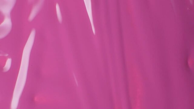 Brush stroke on pink nail polish, macro texture of polish