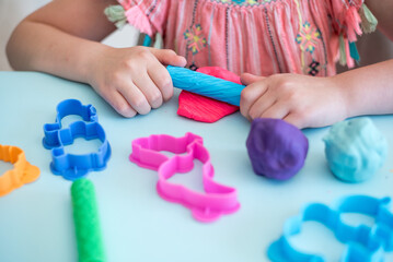 Colorful clay. Child's hands playing with colorful clay. Plasticine. play dough.