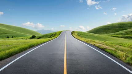 Fototapeta premium A long, curvy road with a blue sky in the background