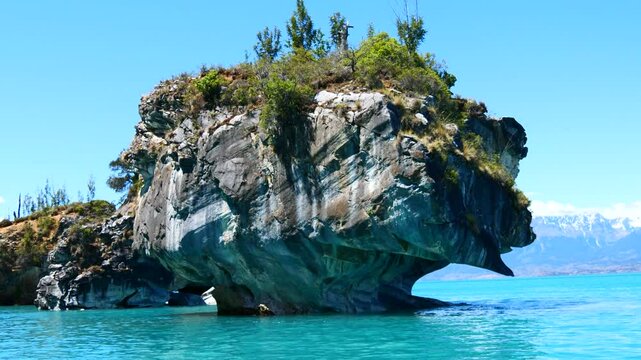Slowly circling the cathedral rock sticking out of the Turquoise water of the lake at the Marble Caves 1 Catedral de Marmol