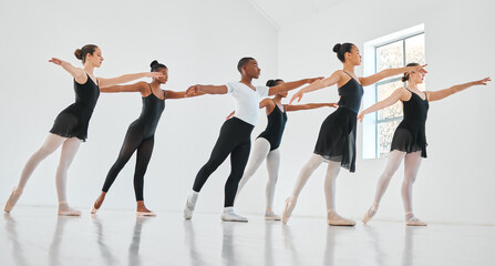 People, ballet and row with dancers in class for balance, art or performance in practice studio. Young group, team or performers in line or artist with talent, elegance or training for choreography © DavisShared/peopleimages.com