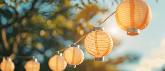 Obraz premium Beautiful string of glowing lanterns hanging outdoors, creating a warm and inviting atmosphere during a sunset.