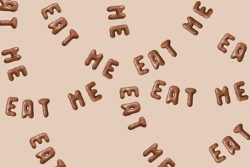 Sweet composition with the words Eat Me on a beige background. Alphabet biscuits on a pastel background, top view