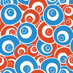 Abstract pattern of blue and red concentric circles on a white background, creating a vibrant and playful design
