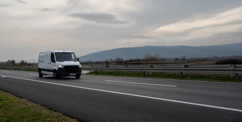White cargo van at the open highway at sunset © Bojan