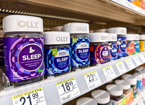 Miami, Florida - Variety of Olly sleep supplements on pharmacy shelf for healthy sleep, with Melatonin and L-Theanine as ingredients.