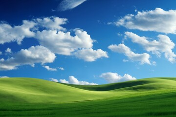 Fototapeta premium A beautiful summer or spring landscape with green grass on the hills and green fields. The blue sky is filled with white clouds and bright sunlight. Nature as a background.