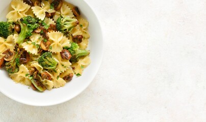 Farfalle pasta with roasted broccoli and mushrooms in bowl