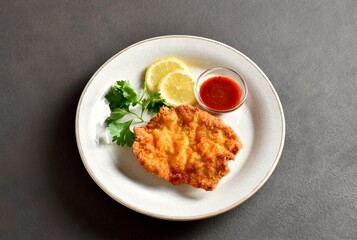 Schnitzel with lemon and leaves of parsley