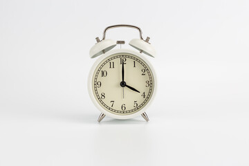 Retro white clock on a white background, the hands show the time at 4:00 AM or 4:00 PM or 16:00