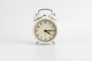 Retro white clock on a white background, the hands show the time at 4:15 AM or 4:15 PM or 16:15