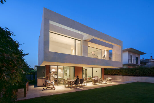 Modern house illuminated at night showcasing sleek design