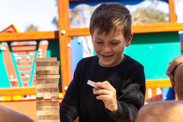 Boy smiling playing game at park with family