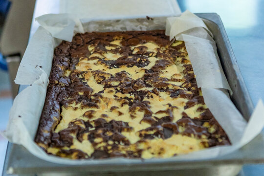 Freshly baked marbled brownie in a metal tray