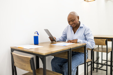 Adult student using a tablet in a classroom