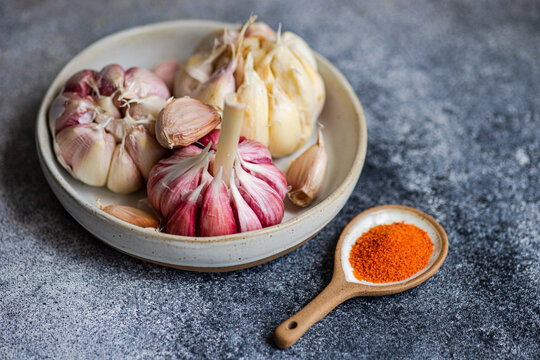 Fresh garlic and spices on a rustic kitchen table