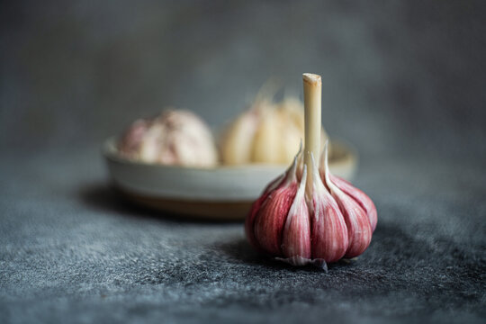 Fresh garlic bulbs on textured backdrop