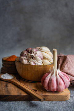 Fresh garlic and spices on rustic wooden table