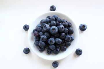 fresh blueberries or bilberry fruit isolated in bowl on white background,top view