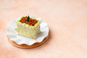 kelepon or klepon cake made from glutinous rice flour and filled with brown sugar covered with grated coconut.