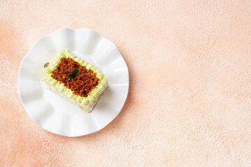 kelepon or klepon cake made from glutinous rice flour and filled with brown sugar covered with grated coconut.