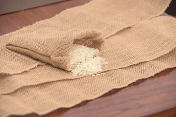 A bag of rice is sitting on a table with a piece of cloth