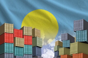 Palau flag and big stack of shipping cargo containers in docks with sky background close up