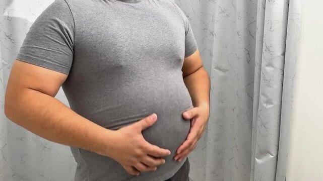 Unhealthy Overweight Man Pinches Fat Stomach,
person with stomach pain