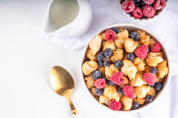 Tiny breakfast croissant cereals with fresh berries and milk