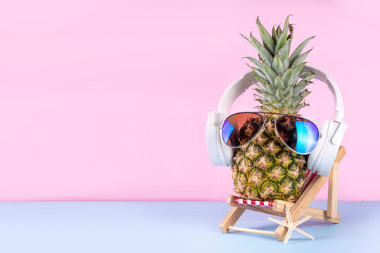Sweet pineapple in sunglasses and headphones