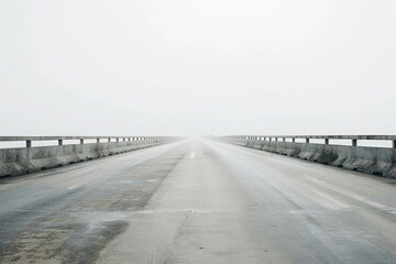 Fototapeta premium A long bridge stretching across a foggy river with misty atmosphere