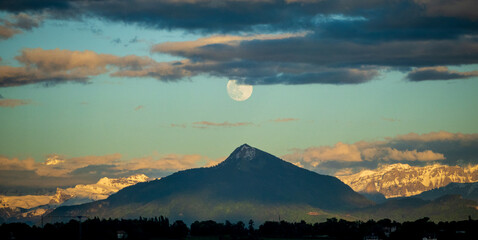 Full moon above a mountain peak in the French alps